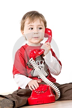 Boy talking on red phone