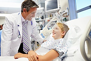 Boy Talking To Male Doctor In Emergency Room