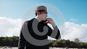 Boy Talks On The Phone At The Sea