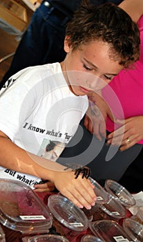 Boy with tarantula on hand