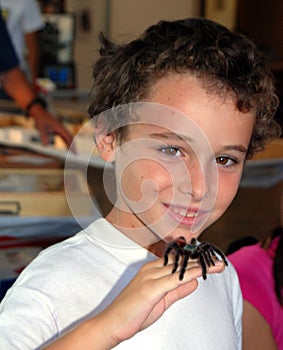Boy with tarantula on hand
