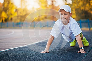 Boy Teen doing sports exercises on a stadium