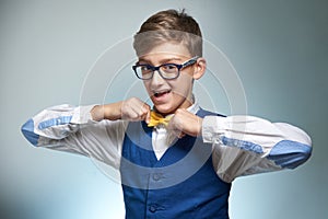 Boy teenager with braces in glasses. Wearing a shirt with a bow tie.