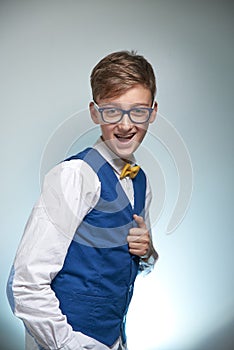 Boy teenager with braces in glasses. Wearing a shirt with a bow tie.