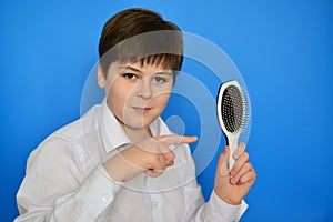 Boy teenager with comb in his hand