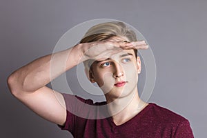 Boy teenager looks away with raised arm