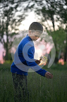 Boy teenager on a red sunset background.