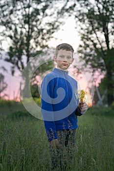 Boy teenager on a red sunset background.