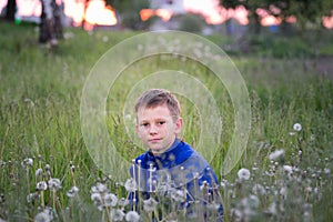 Boy teenager on a red sunset background.