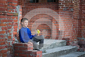 Boy teenager sitting on porch at home