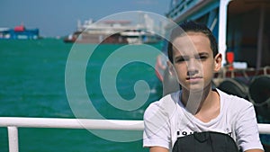 Boy teenager suffers from motion sickness while on a boat trip. Fear of traveling or illness of the virus during a