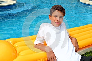 Boy teenager vacation holidays rest on pool float