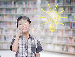 Boy think with light bumb in library