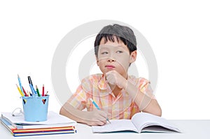 Boy thinking between doing homework