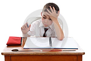 Boy thinkinhg at school desk