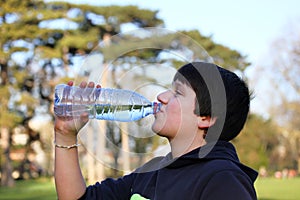 Boy thirsty eagerly drinking water