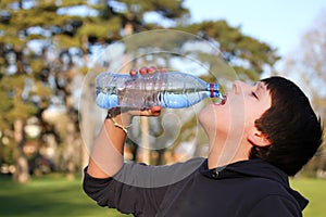 Boy thirsty eagerly drinking water