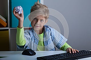 Boy throwing ball of paper