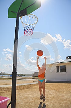 Boy throwing ball to basket