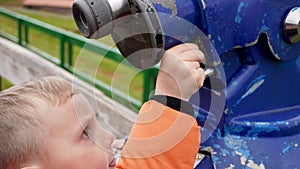 boy throwing a coin into paid binoculars