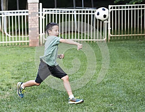 Boy throwing a soccer boy
