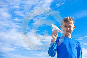 Boy throwing white paper plane.