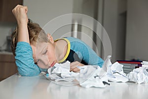 Boy tired and bored of doing homework