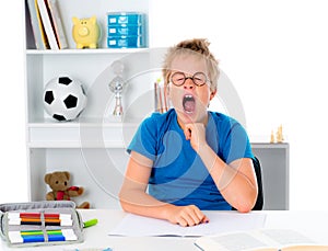 Boy is tired by the homework