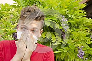 Boy with tissue covering his nose, allergies