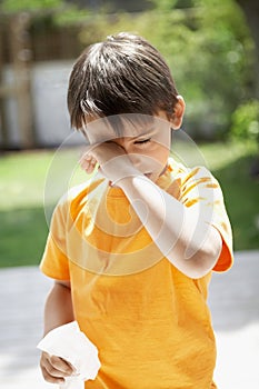 Boy With Tissue Paper Rubbing Eye