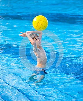 Boy about to hit a ball in swimming pool