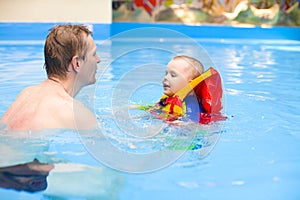 Boy to swim in pool with father