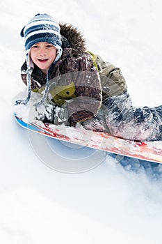 Boy tobogganing