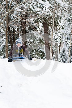 Boy tobogganing