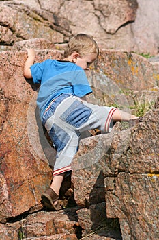 Boy Toddler Climbing a Rock