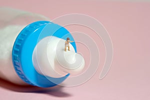 A boy toddler infant whimpering, walking above milk bottle pacifier. Isolated on pink background.