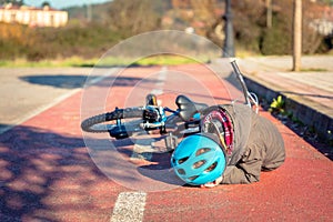 Boy touching his head after falling off to bicycle