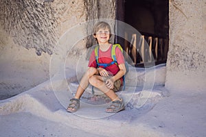 Boy tourist exploring valley with rock formations and fairy caves near Goreme in Cappadocia Turkey