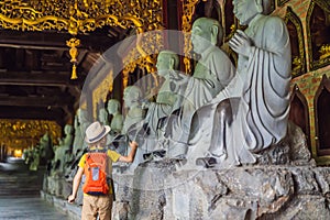 Boy tourist in Temple tower of Bai Dinh pagoda in Ninh Binh, Vietnam. Resumption of tourism in Vietnam after quarantine