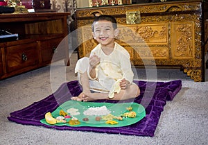 Boy with traditional clothes on onam day and having lunch