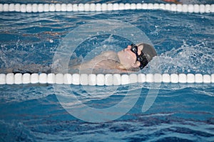 The boy trains in swimming pool, before the compet
