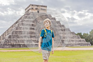 Boy traveler, tourists observing the old pyramid and temple of the castle of the Mayan architecture known as Chichen