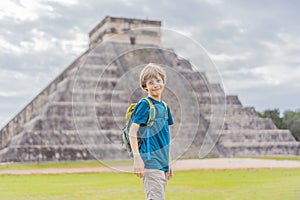 Boy traveler, tourists observing the old pyramid and temple of the castle of the Mayan architecture known as Chichen