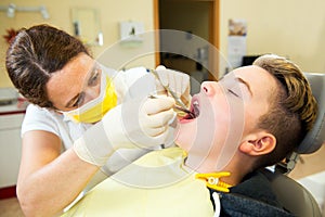Boy is treated by female dentist