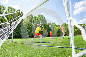 Boy tries to catch with his hands the football