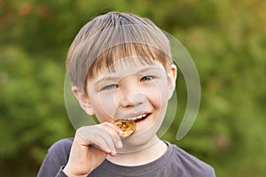 Boy trying to taste the Bitcoin in the summer in the Park.