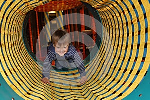 Boy in tunnel on playground