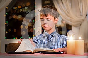 Boy turning page of book.