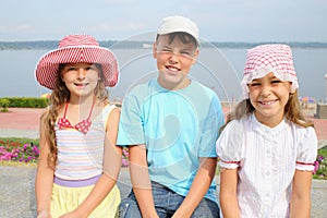 boy and two girl on river embankment