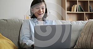 Boy Typing on Laptop and Expressing Amazement on Living Room Couch